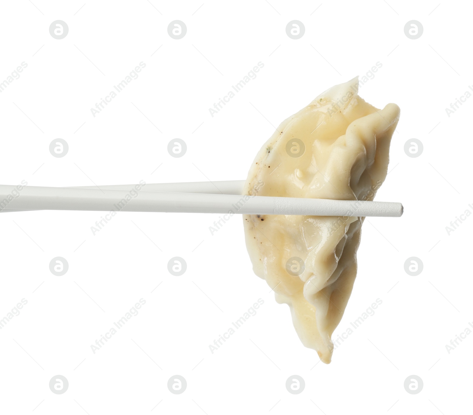 Photo of Chopsticks with tasty boiled gyoza (dumpling) on white background