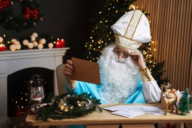 Saint Nicholas with letter in room decorated for Christmas