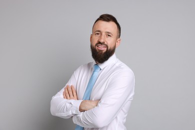 Photo of Handsome bearded man in formal outfit on grey background