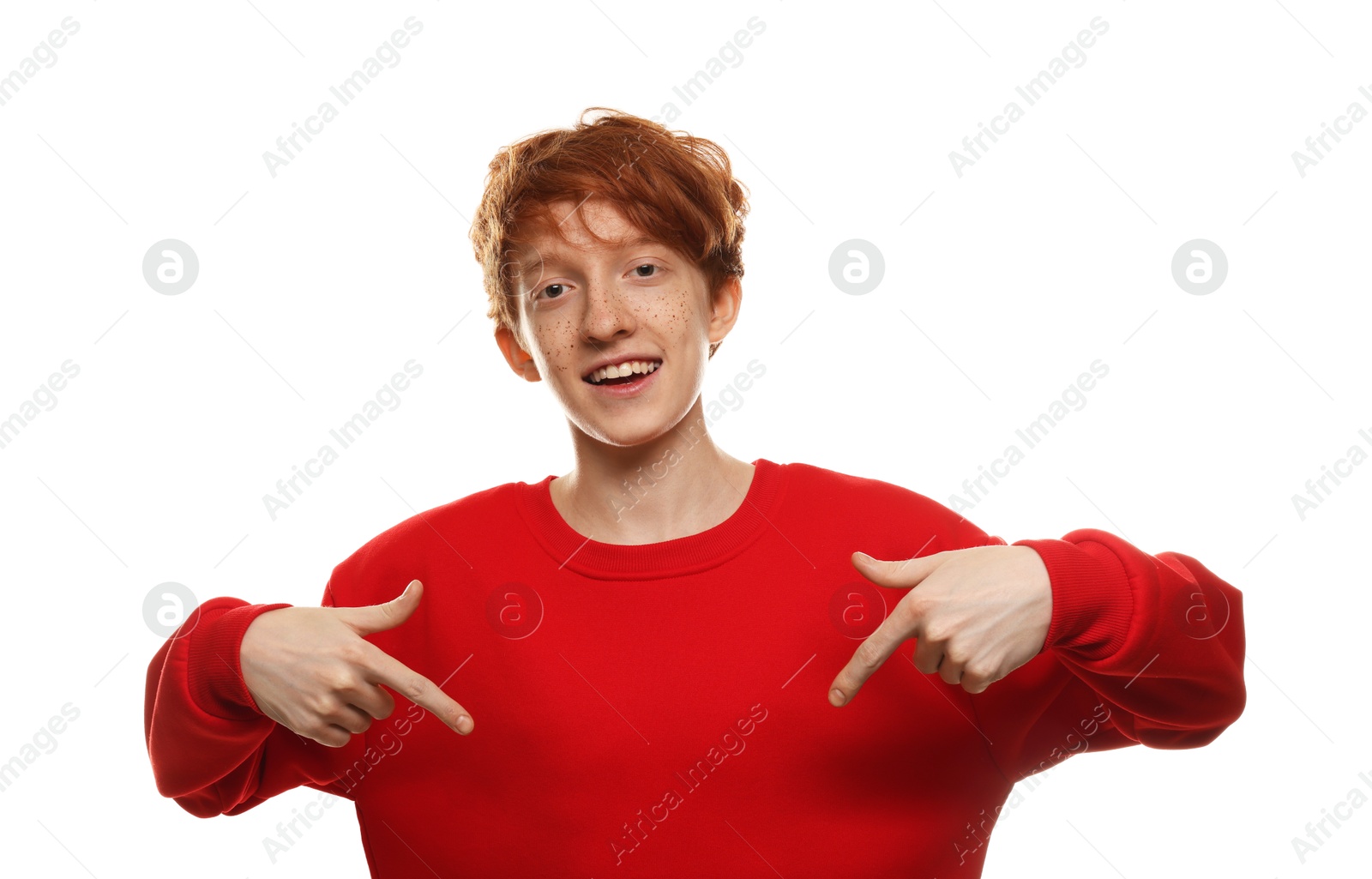 Photo of Smiling teenage boy with freckles gesturing on white background