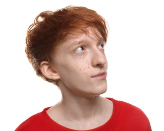 Photo of Cute teenage boy with freckles on white background