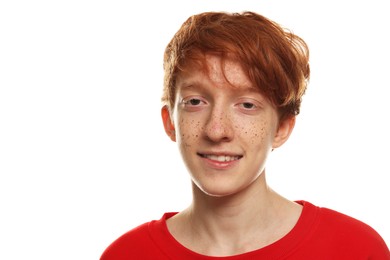 Portrait of smiling teenage boy with freckles on white background