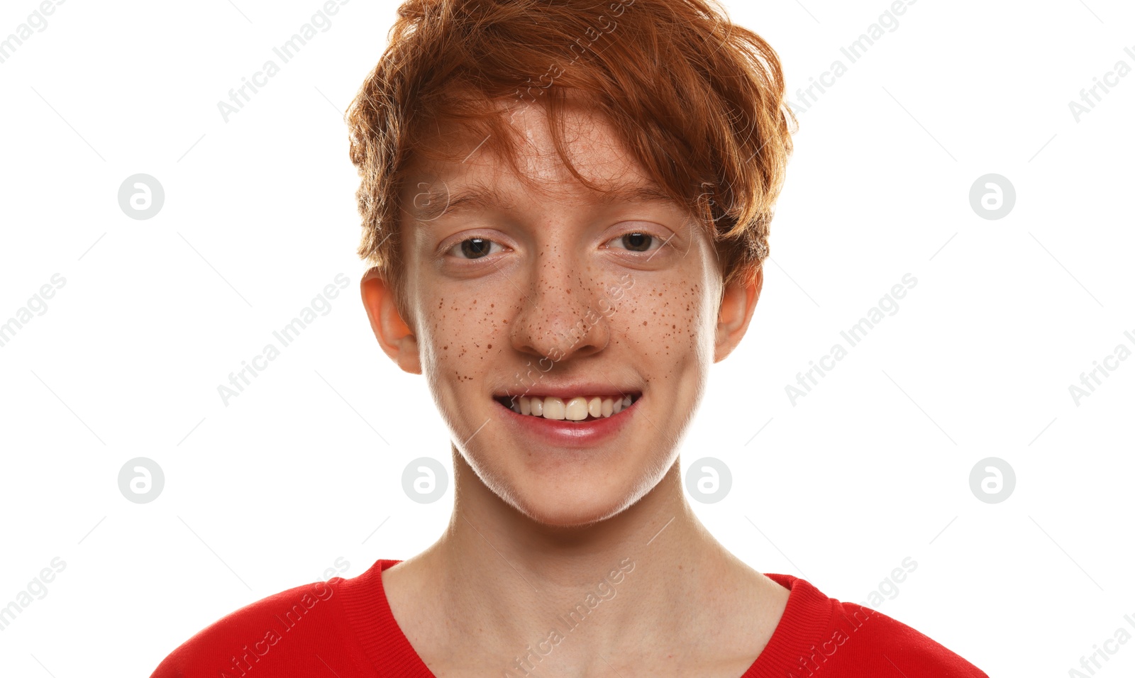 Photo of Portrait of smiling teenage boy with freckles on white background