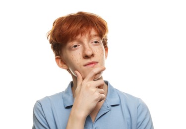 Thoughtful teenage boy with freckles on white background