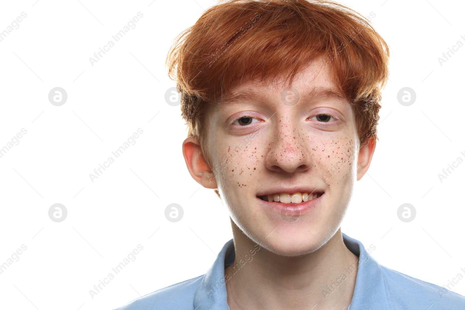 Photo of Portrait of smiling teenage boy with freckles on white background