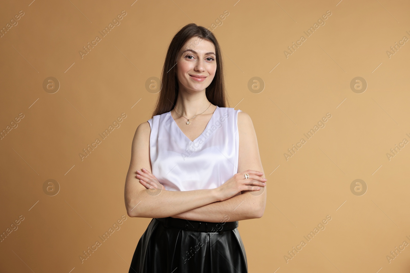 Photo of Beautiful woman in stylish outfit on beige background