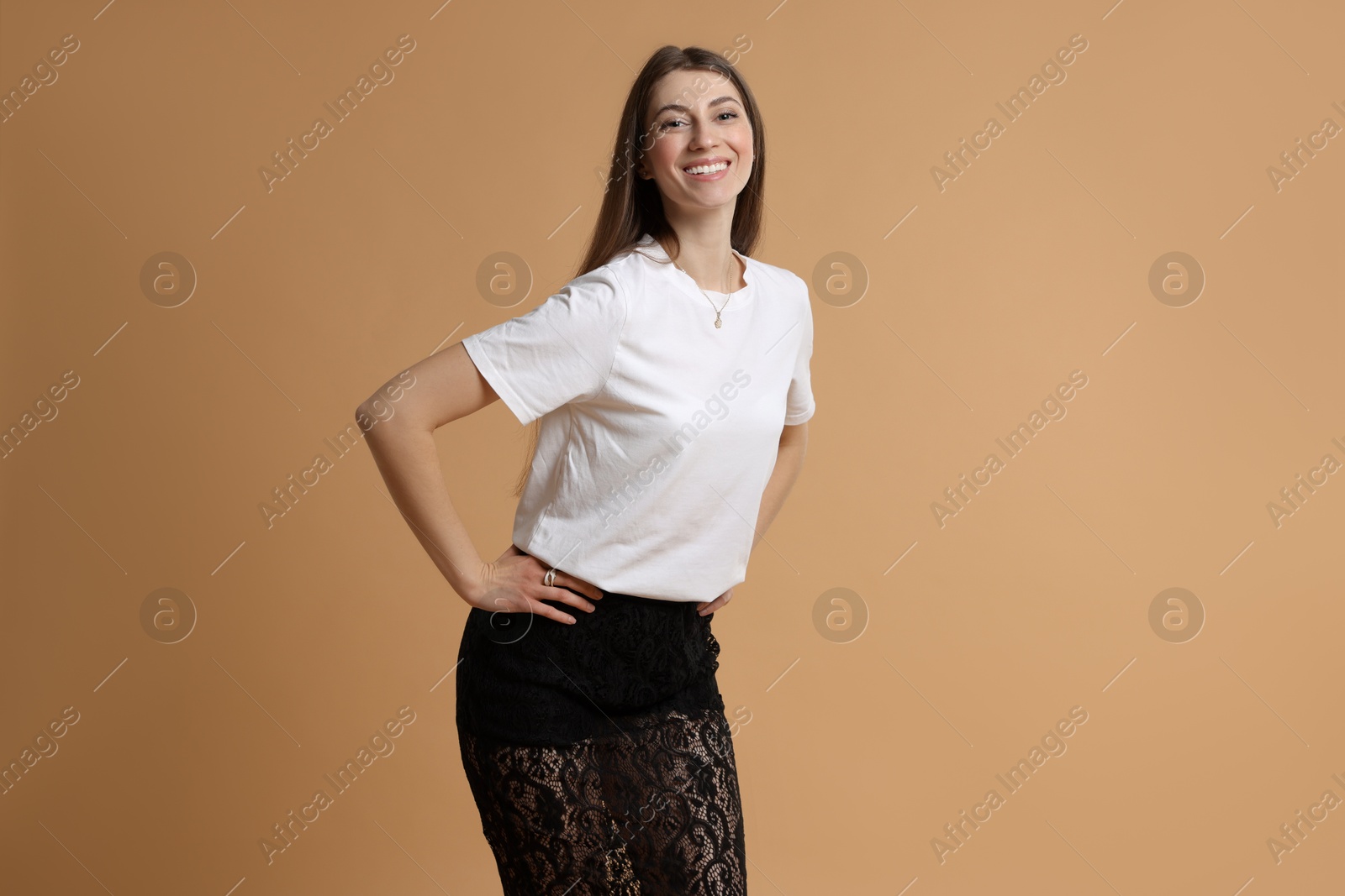 Photo of Beautiful woman in stylish outfit on beige background