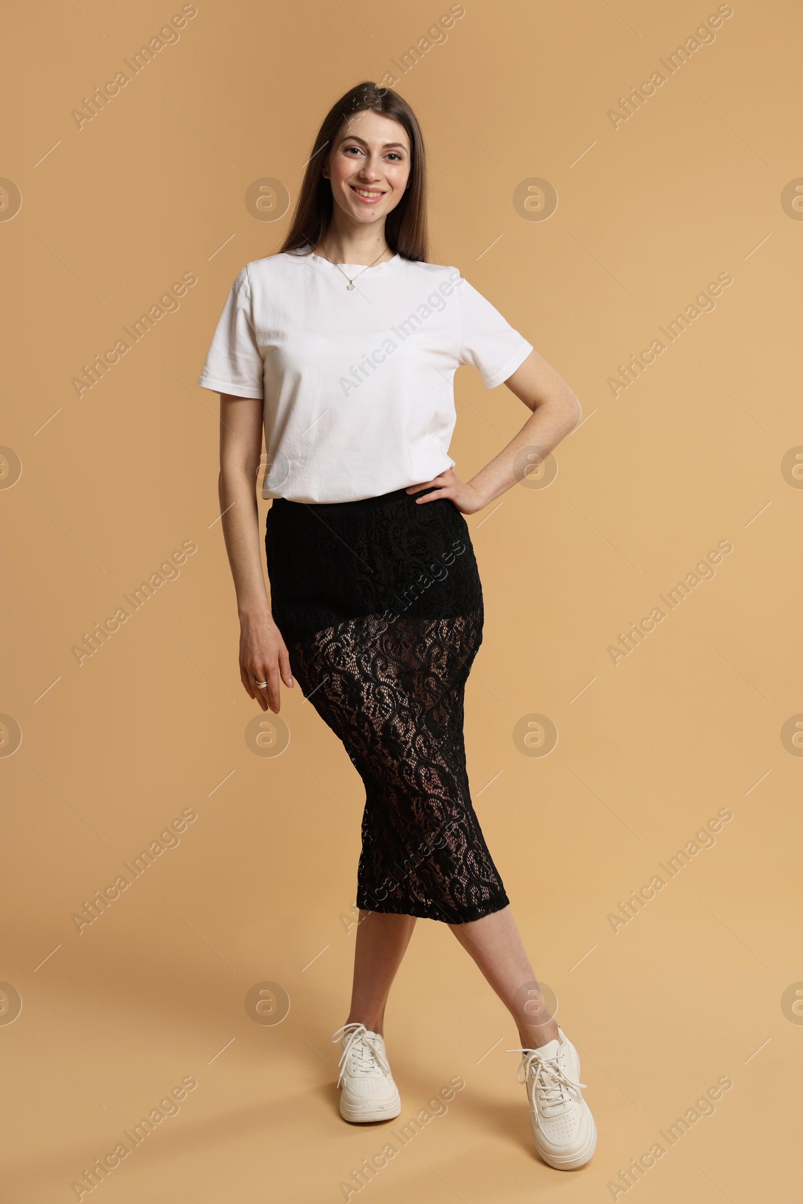 Photo of Beautiful woman in stylish outfit on beige background