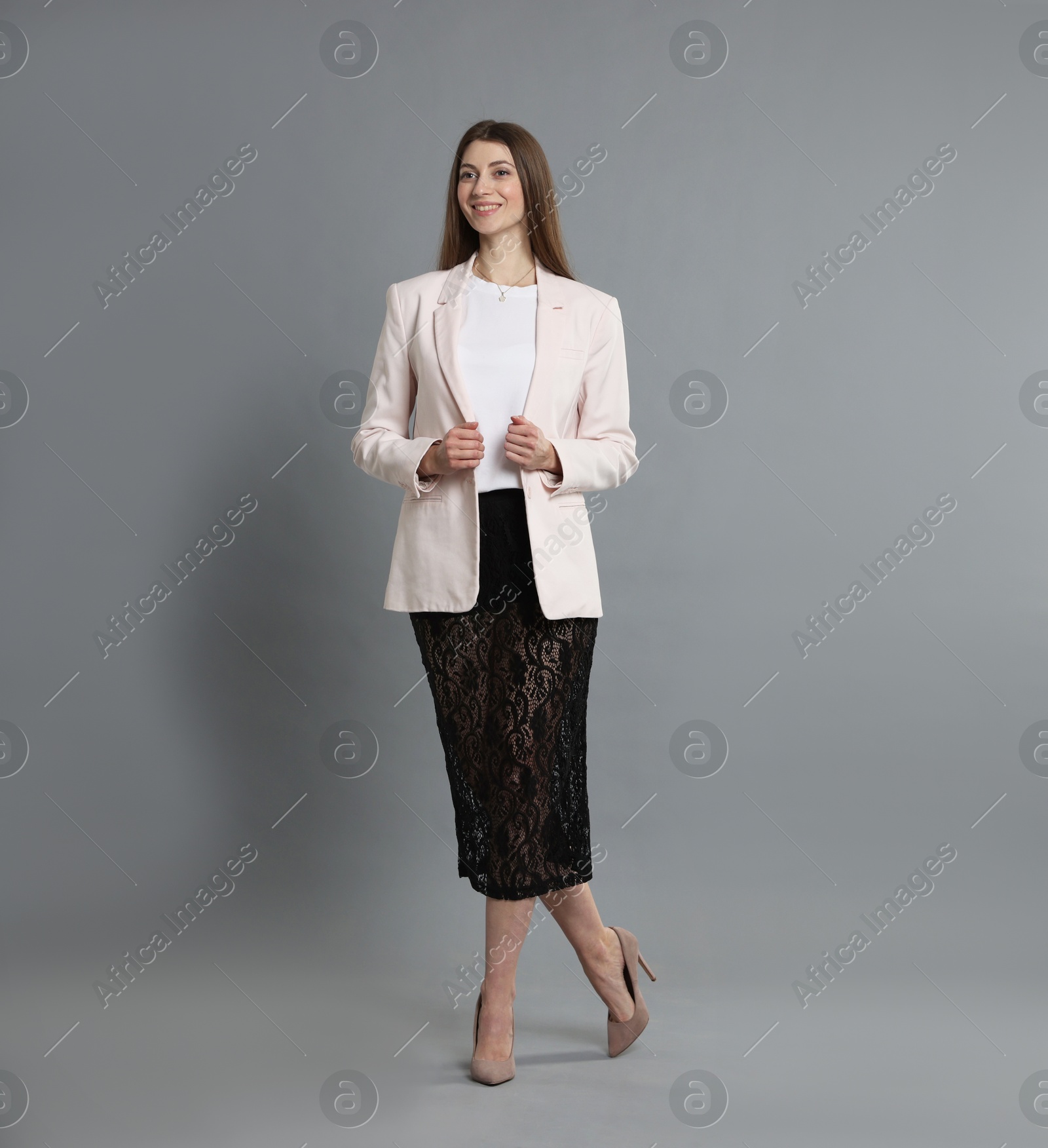 Photo of Beautiful woman in stylish outfit on grey background