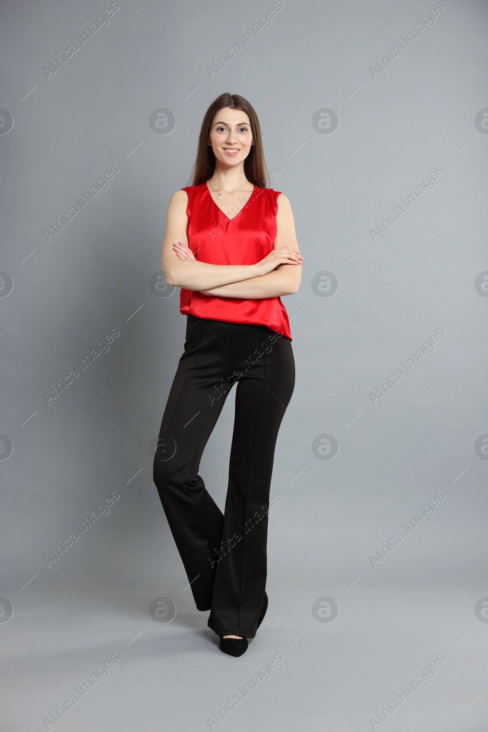 Photo of Beautiful woman in stylish outfit on grey background