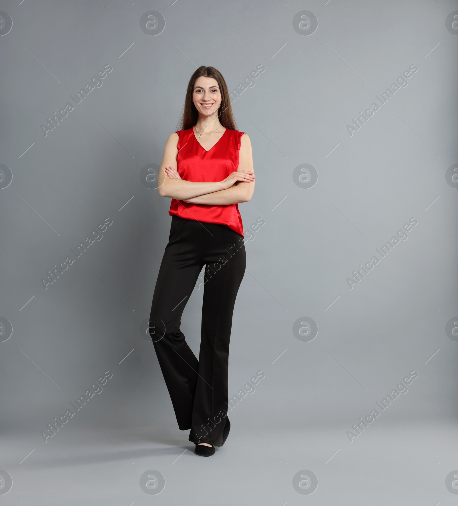 Photo of Beautiful woman in stylish outfit on grey background