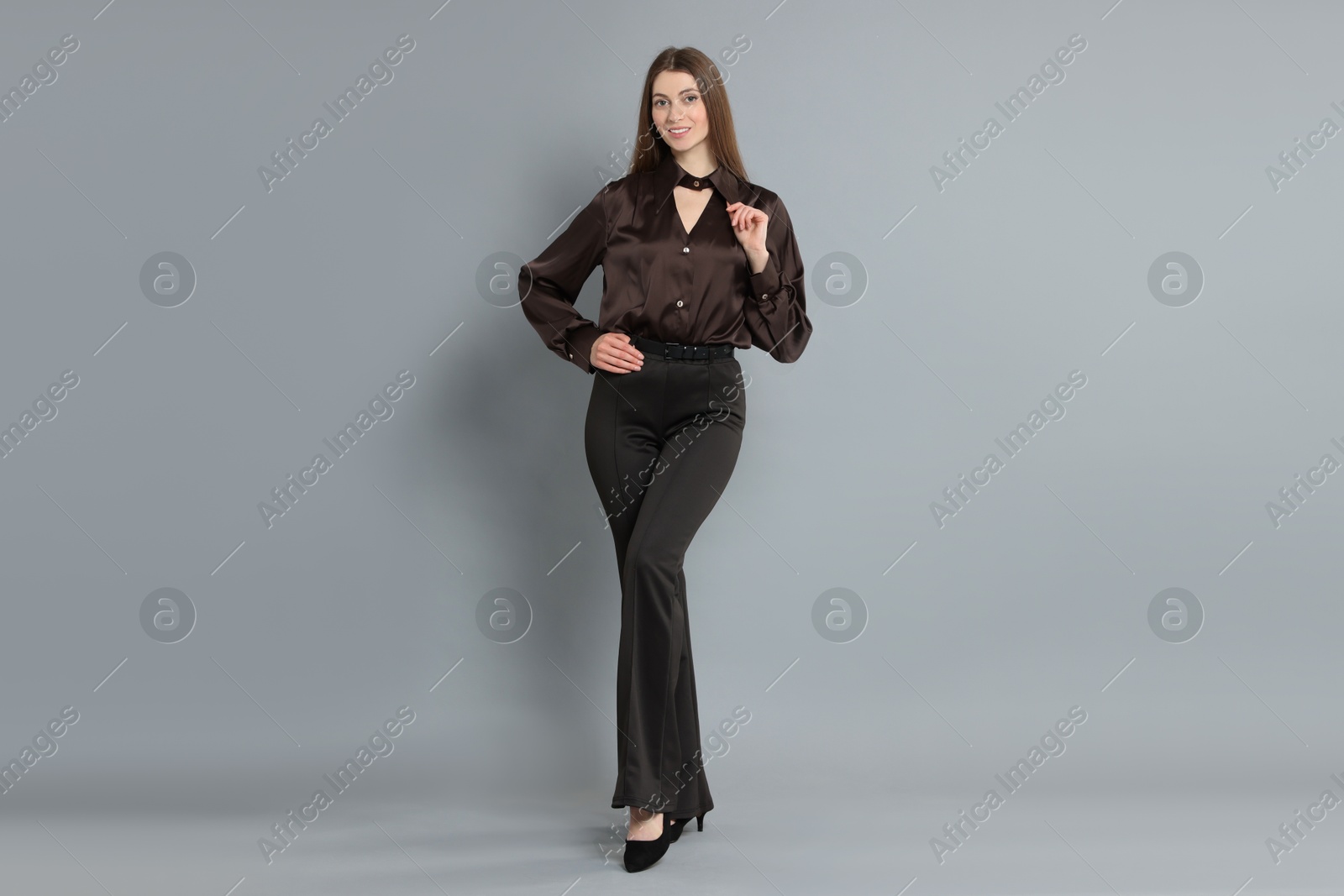 Photo of Beautiful woman in stylish outfit on grey background