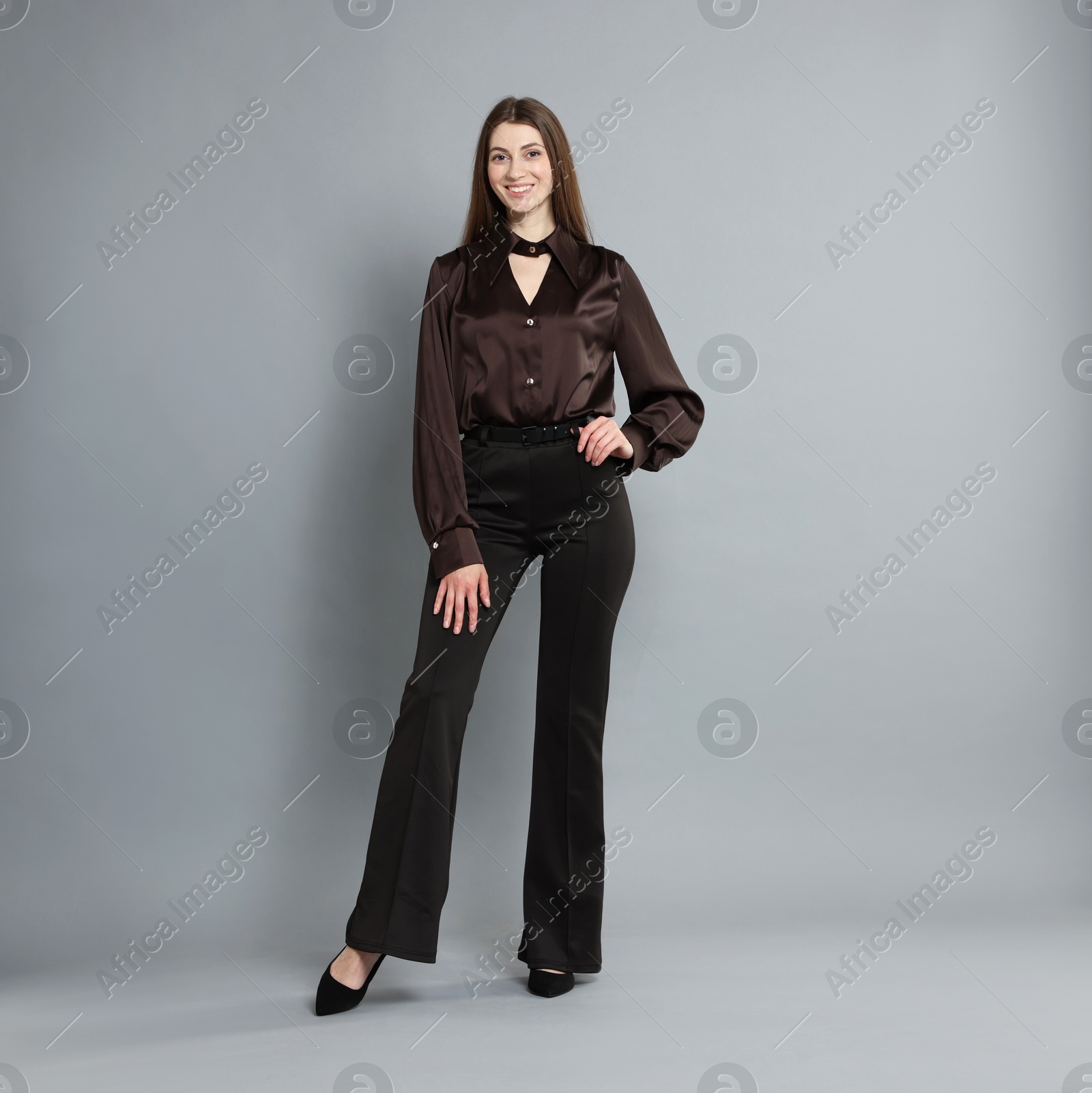 Photo of Beautiful woman in stylish outfit on grey background