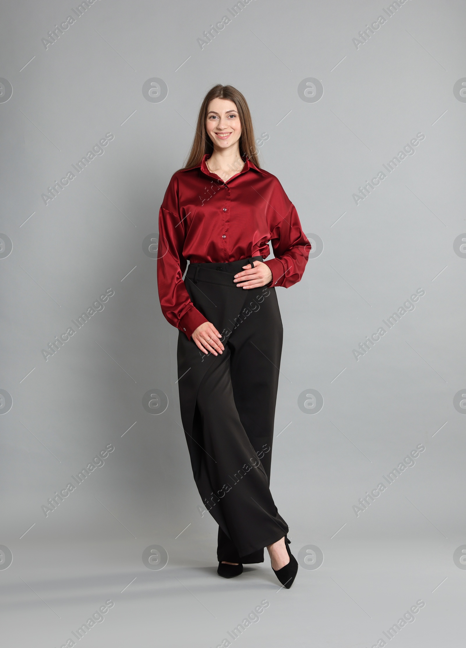 Photo of Beautiful woman in stylish outfit on grey background