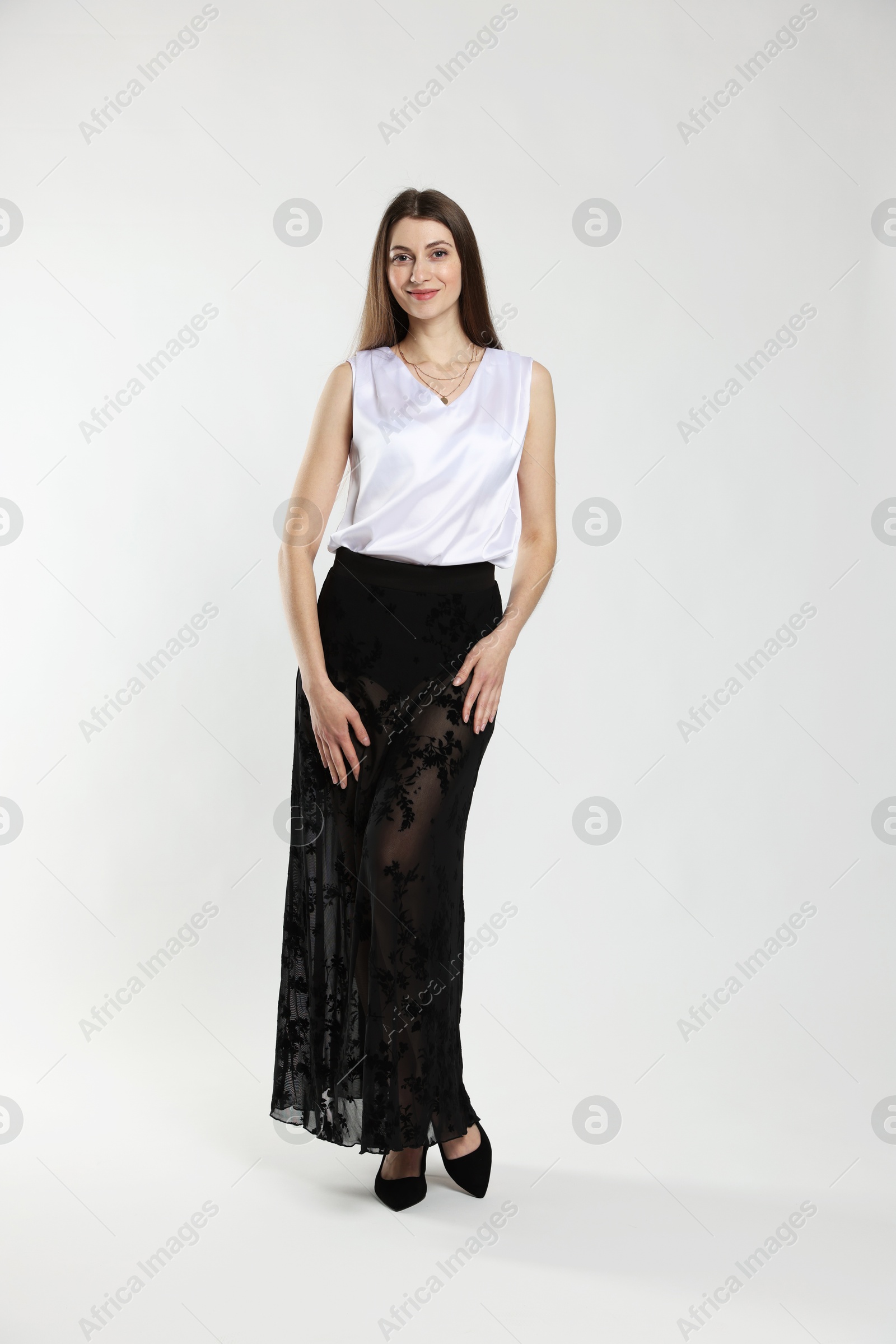 Photo of Beautiful woman in stylish outfit on white background