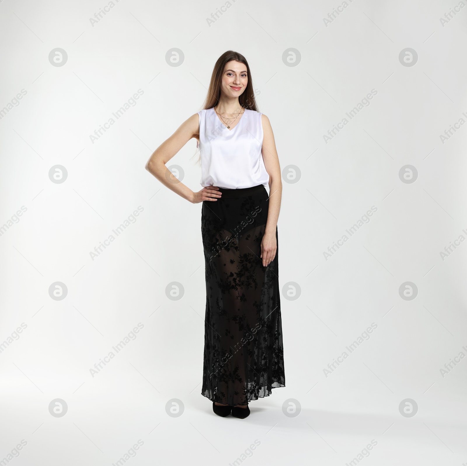 Photo of Beautiful woman in stylish outfit on white background