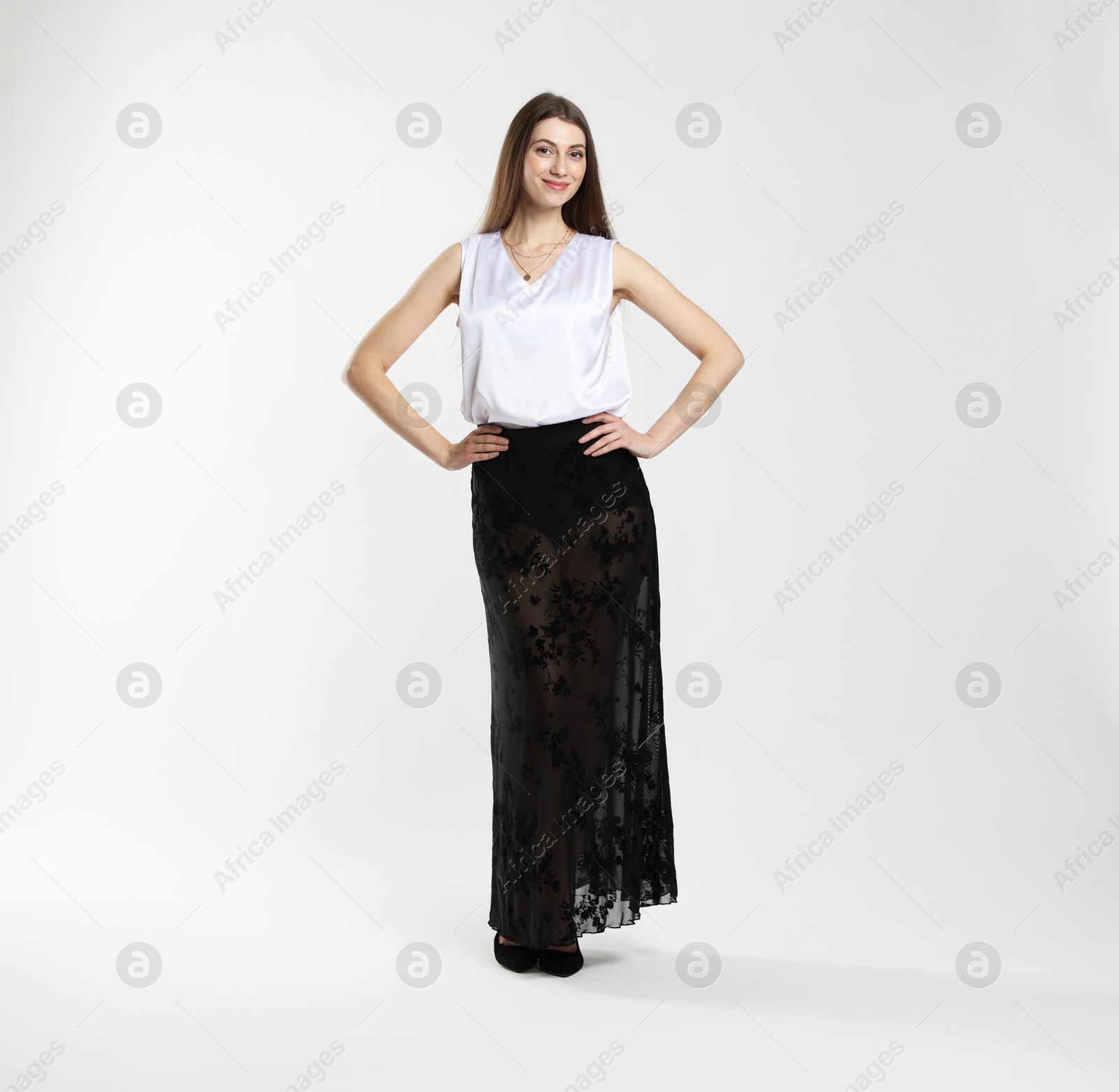 Photo of Beautiful woman in stylish outfit on white background