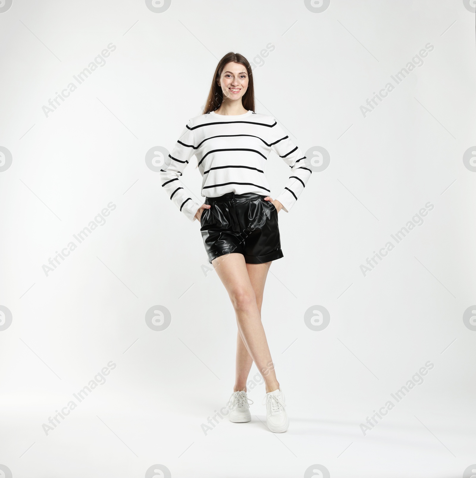 Photo of Beautiful woman in stylish outfit on white background