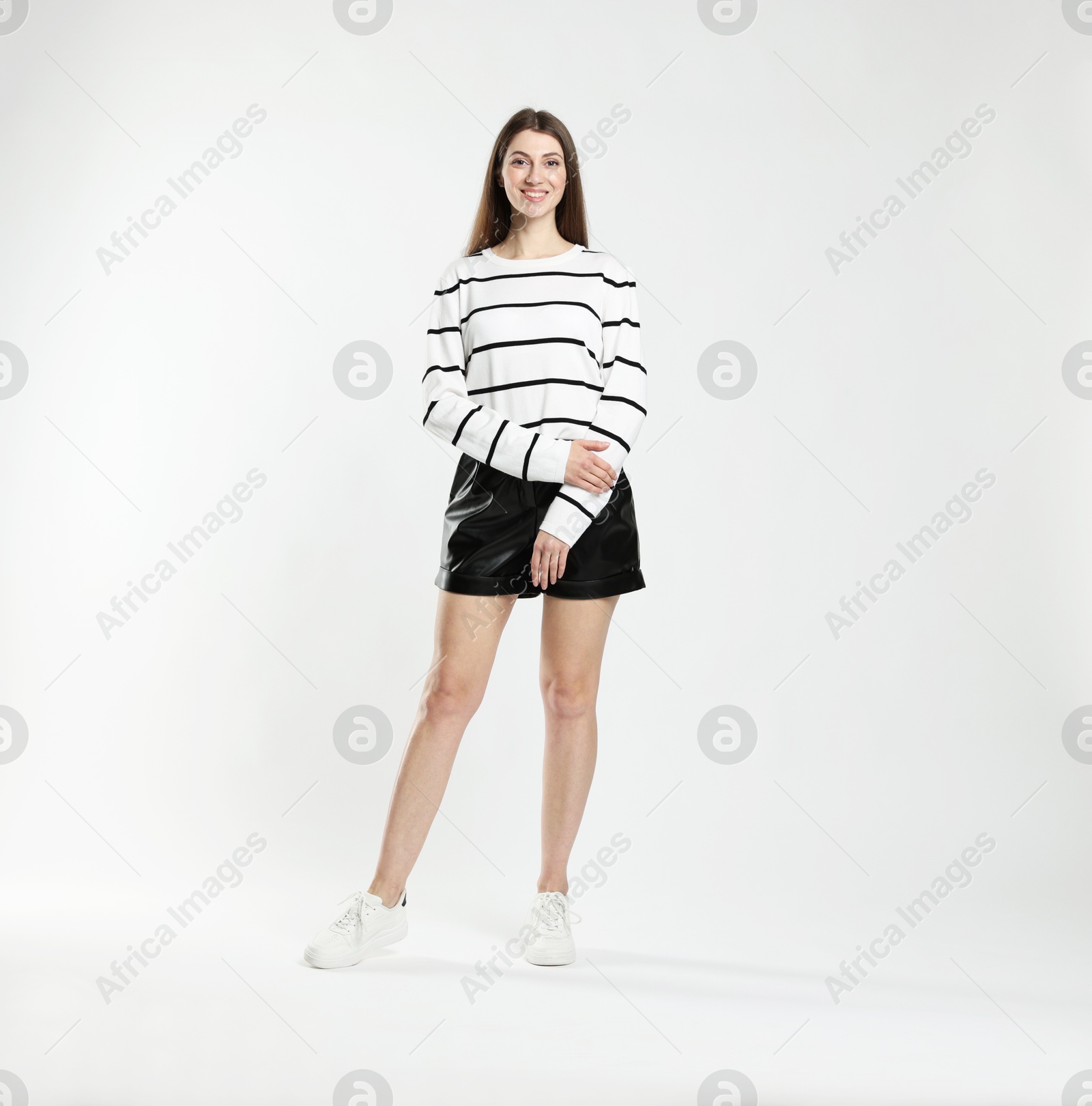 Photo of Beautiful woman in stylish outfit on white background