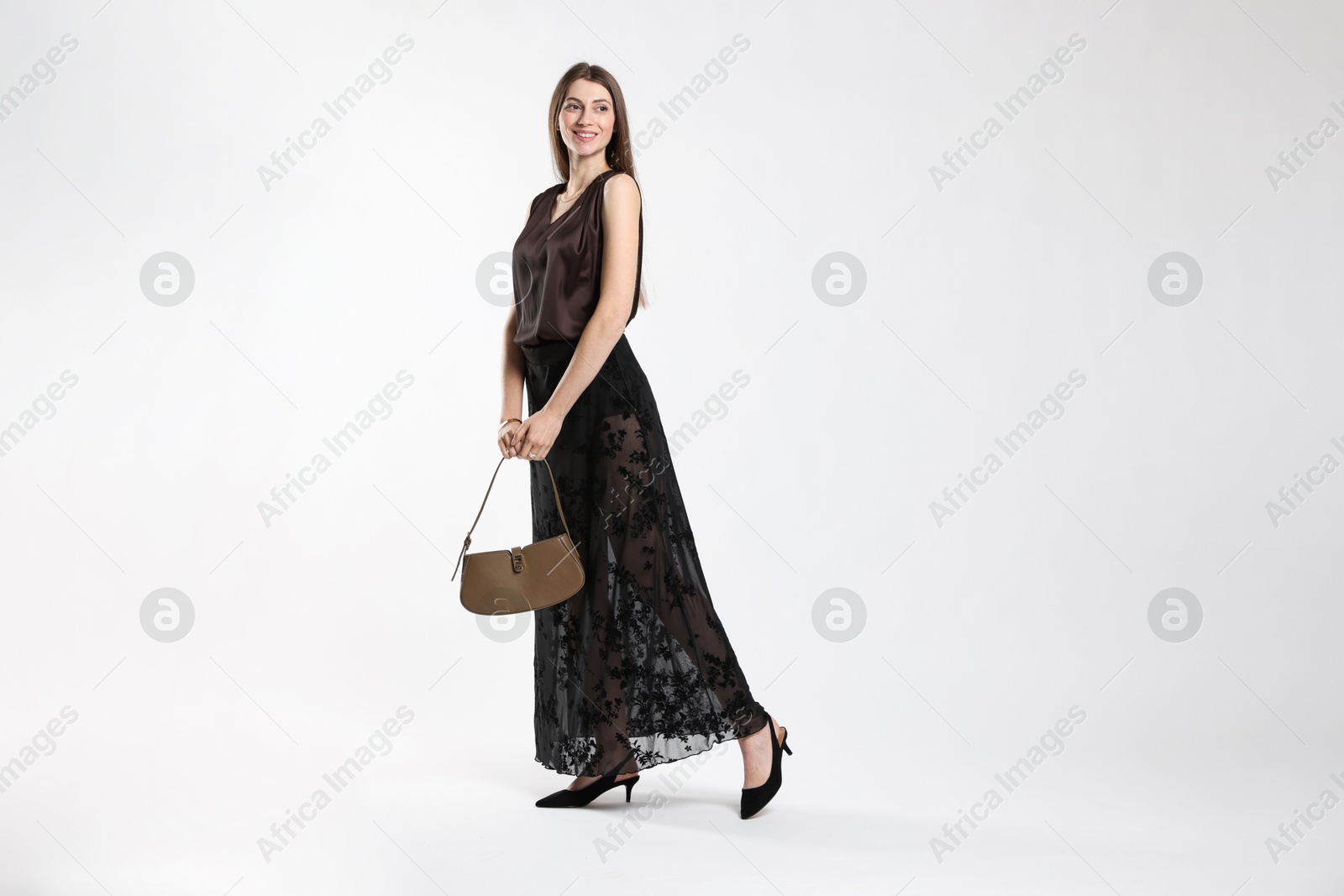 Photo of Beautiful woman in stylish outfit on white background