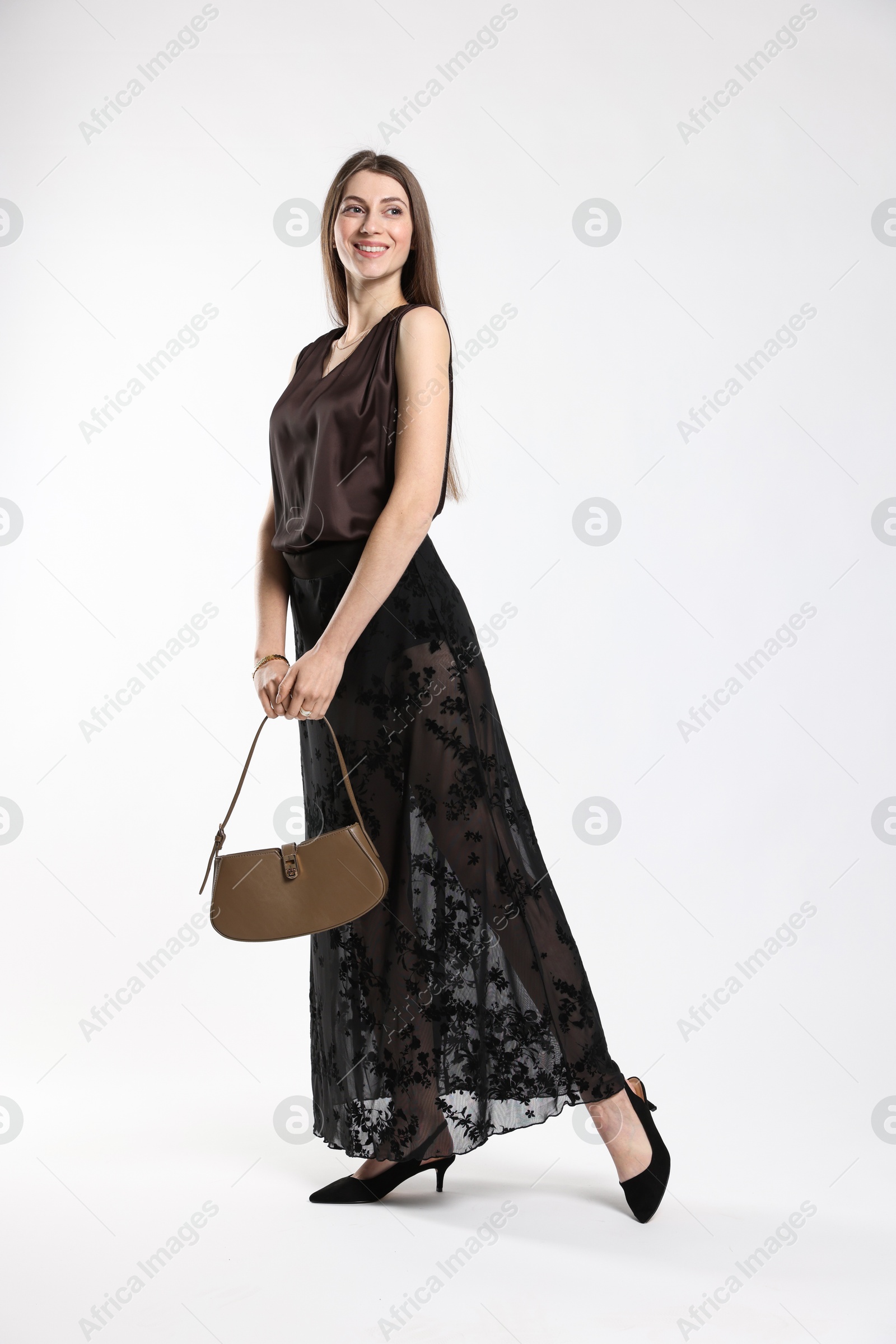 Photo of Beautiful woman in stylish outfit on white background