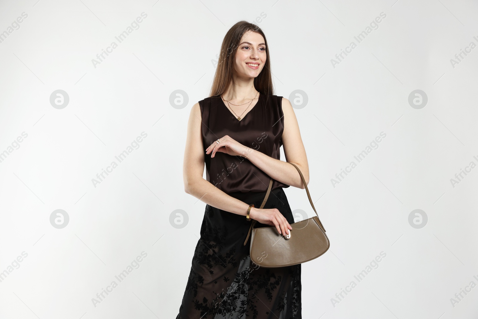 Photo of Beautiful woman in stylish outfit on white background