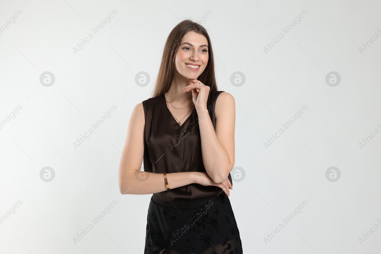 Photo of Beautiful woman in stylish outfit on white background