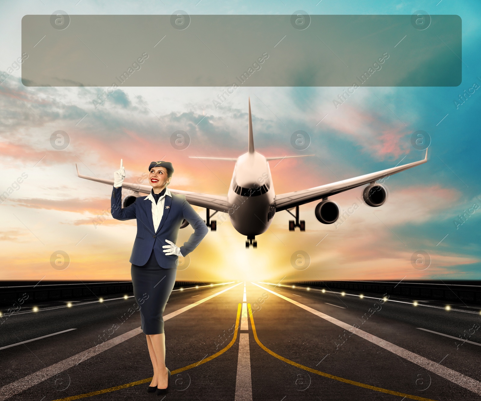 Image of Smiling stewardess pointing at space for aviation promotion on runway. Airplane landing behind her