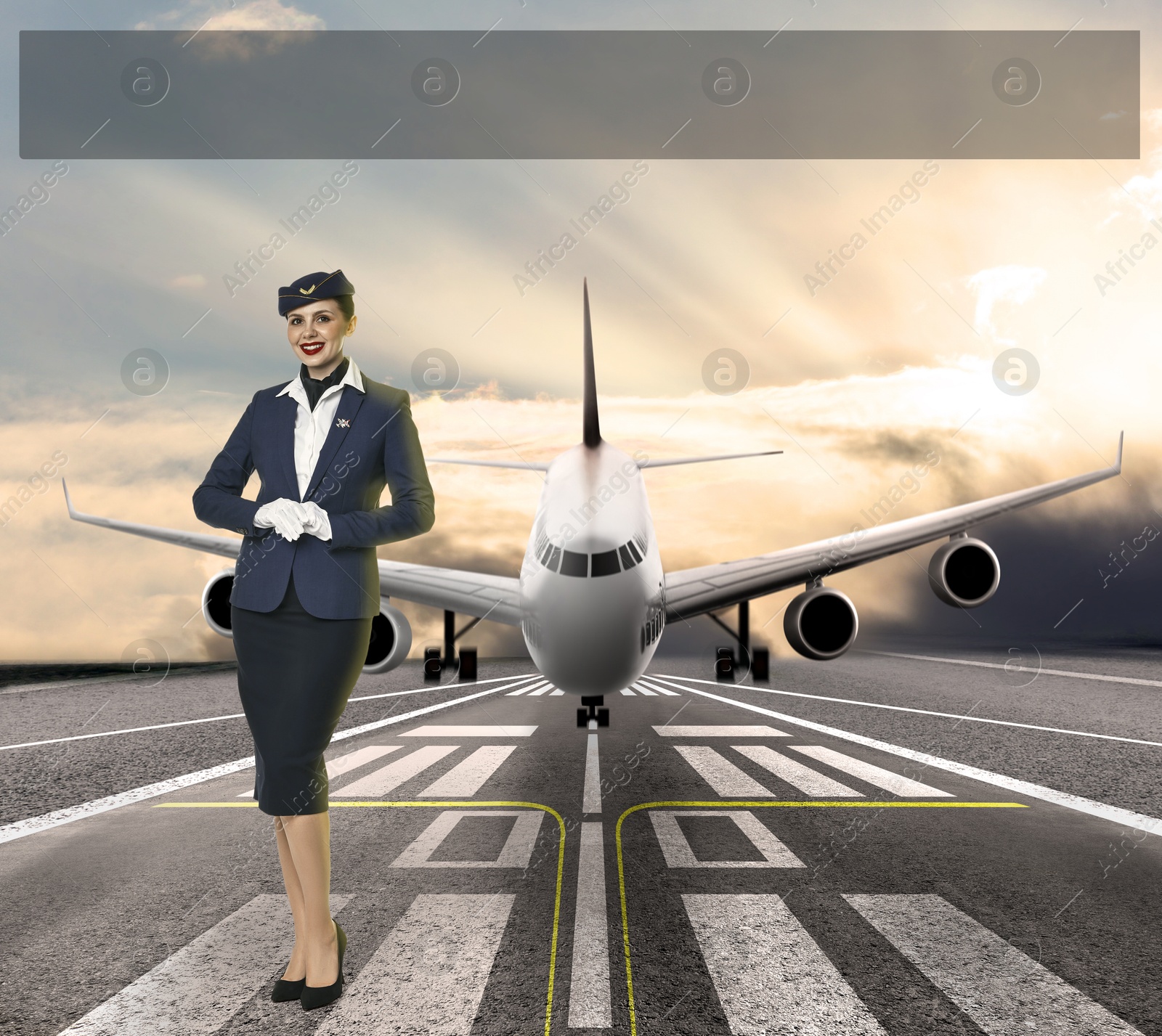 Image of Smiling stewardess in uniform on runway. Airplane landing behind her