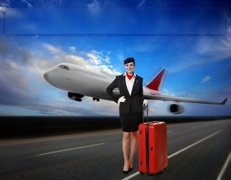 Smiling stewardess with suitcase on runway. Airplane taking off behind her