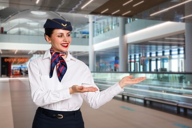 Image of Smiling stewardess welcoming passengers to airport terminal