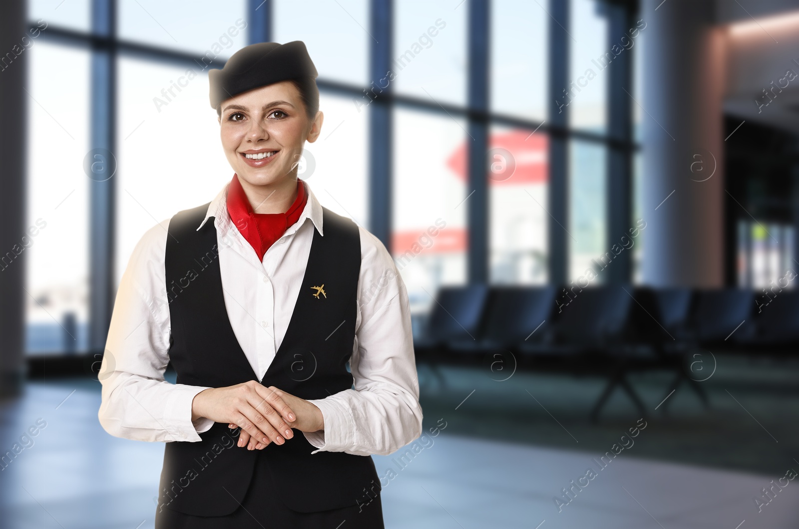 Image of Smiling stewardess in waiting area at airport. Space for text