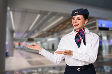 Smiling stewardess welcoming passengers to airport terminal