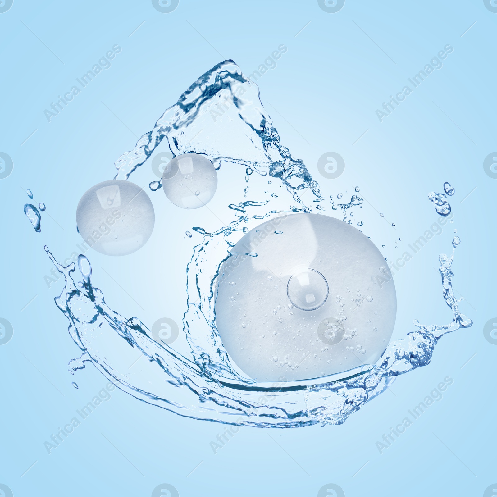 Drops of cosmetic serum and splashing water on light blue background Image of Drops of cosmetic serum and splashing water on light blue background