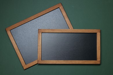 Photo of Blank small blackboards on green background, top view