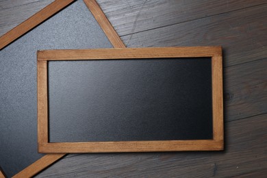 Photo of Blank small blackboards on wooden background, top view