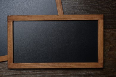 Photo of Blank small blackboards on wooden background, top view