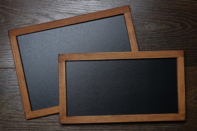 Photo of Blank small blackboards on wooden background, top view