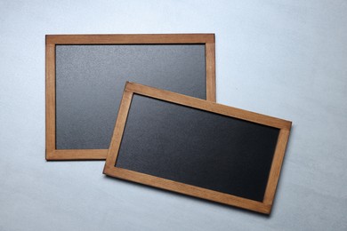 Photo of Blank small blackboards on gray textured background, top view