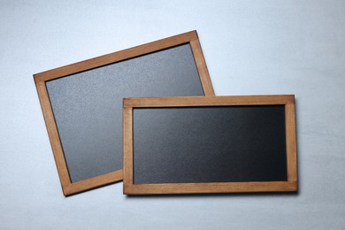 Photo of Blank small blackboards on gray textured background, top view