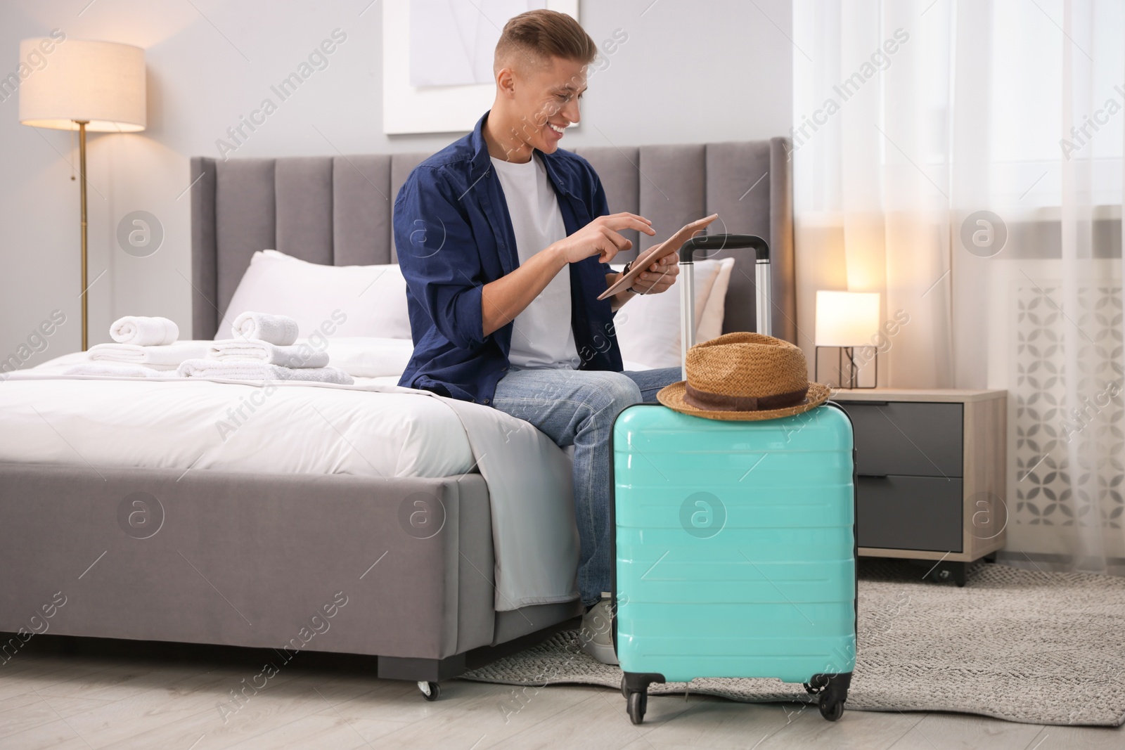 Photo of Man with tablet in his hotel room