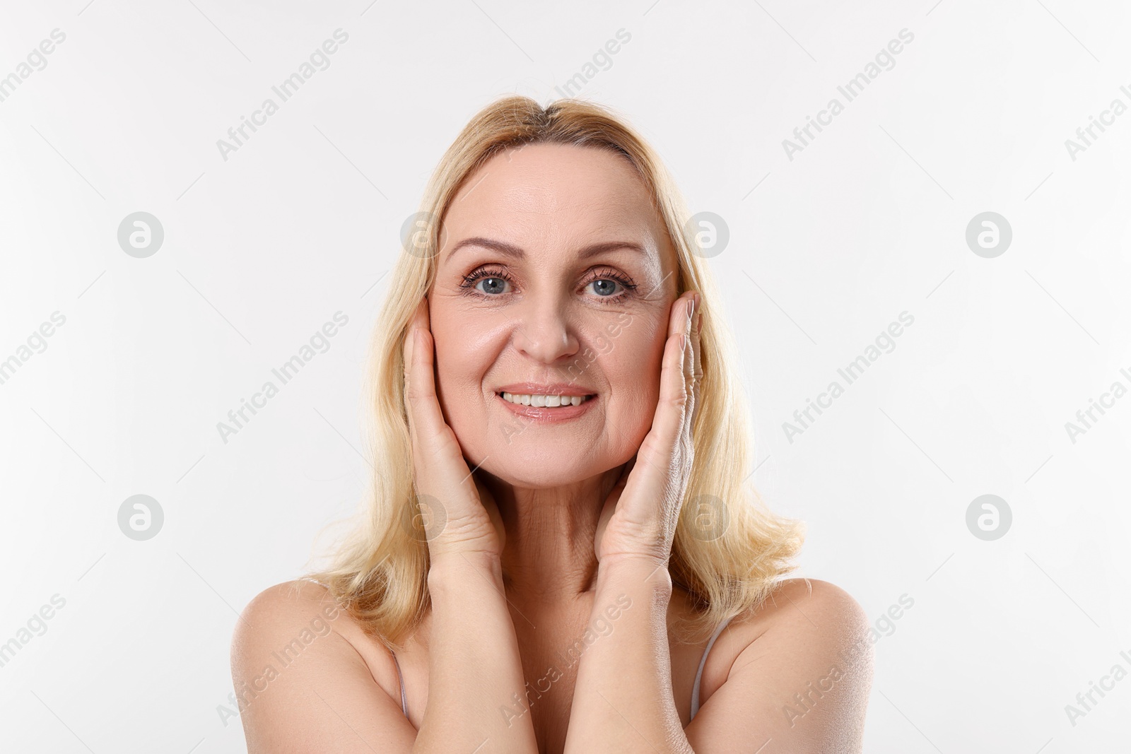 Photo of Portrait of smiling middle aged woman on white background