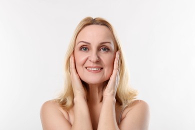 Photo of Portrait of smiling middle aged woman on white background