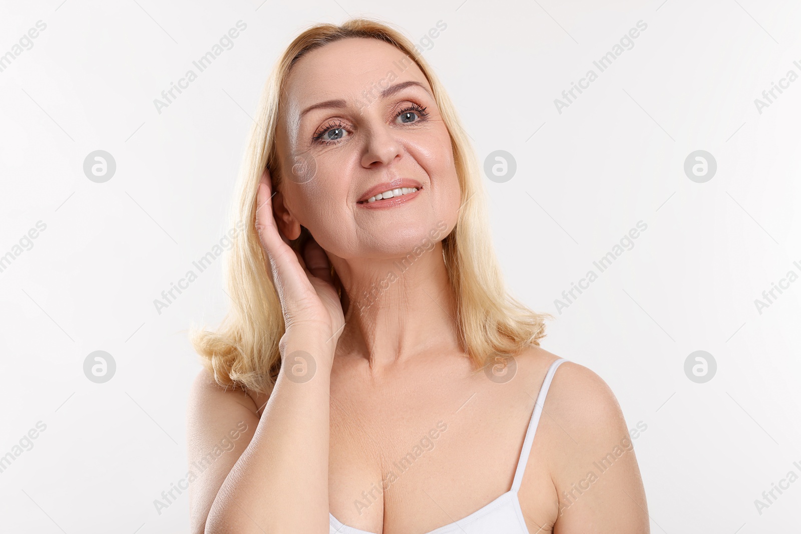 Photo of Smiling middle aged woman on white background. Space for text