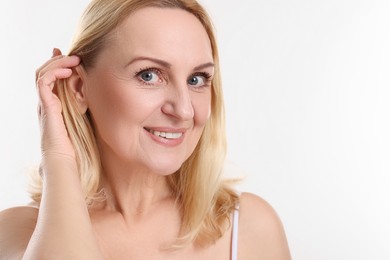 Portrait of smiling middle aged woman on white background. Space for text