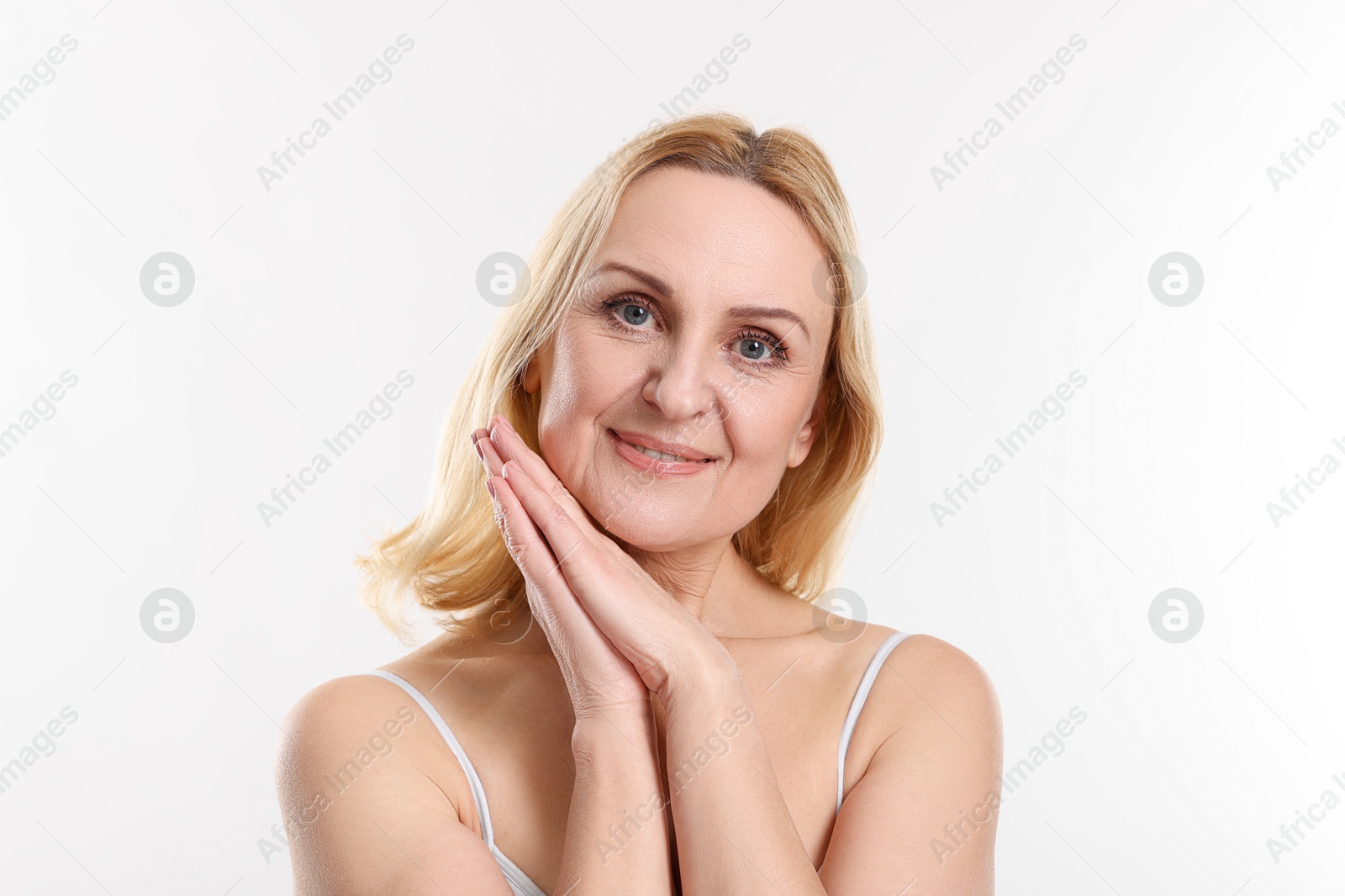 Photo of Portrait of smiling middle aged woman on white background