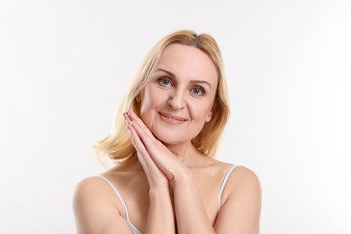 Portrait of smiling middle aged woman on white background