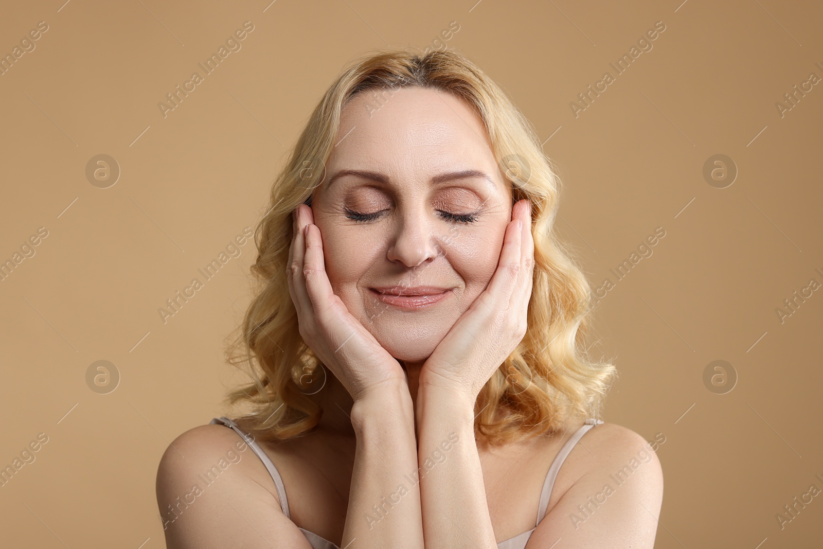 Photo of Beautiful middle aged woman on beige background