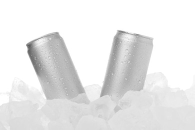 Photo of Refreshing drinks in cans on ice cubes against white background