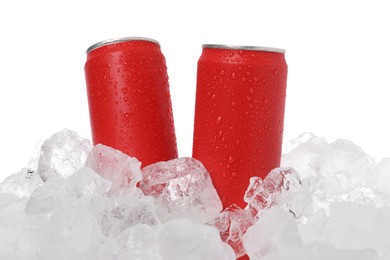 Photo of Refreshing drinks in cans on ice cubes against white background